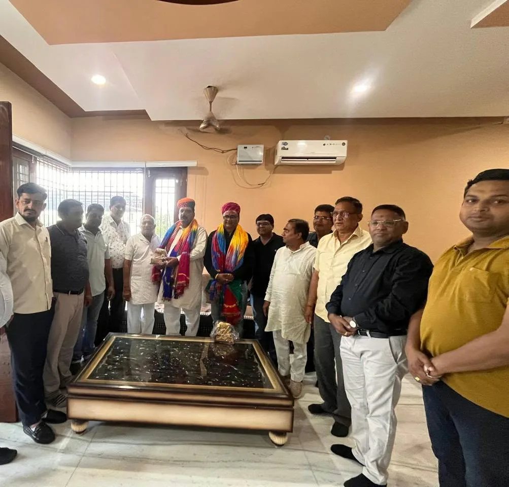 State Minister Vijay Singh Chaudhary and Chairman Mahesh Ramchandka being honored at a gathering